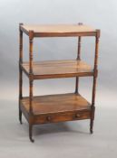An early Victorian rosewood whatnot,with three stages and base drawer, on ring turned tapered legs