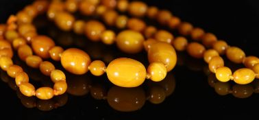 A single strand graduated oval amber bead necklace with round bead spacers,88cm, gross 82 grams,