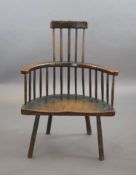 An 18th century primitive vernacular comb-back elbow chair, possibly Welsh,with remnants of