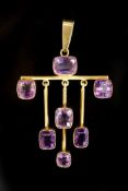 A stylish early 20th century gold and seven stone amethyst set drop pendant,overall 6cm, gross