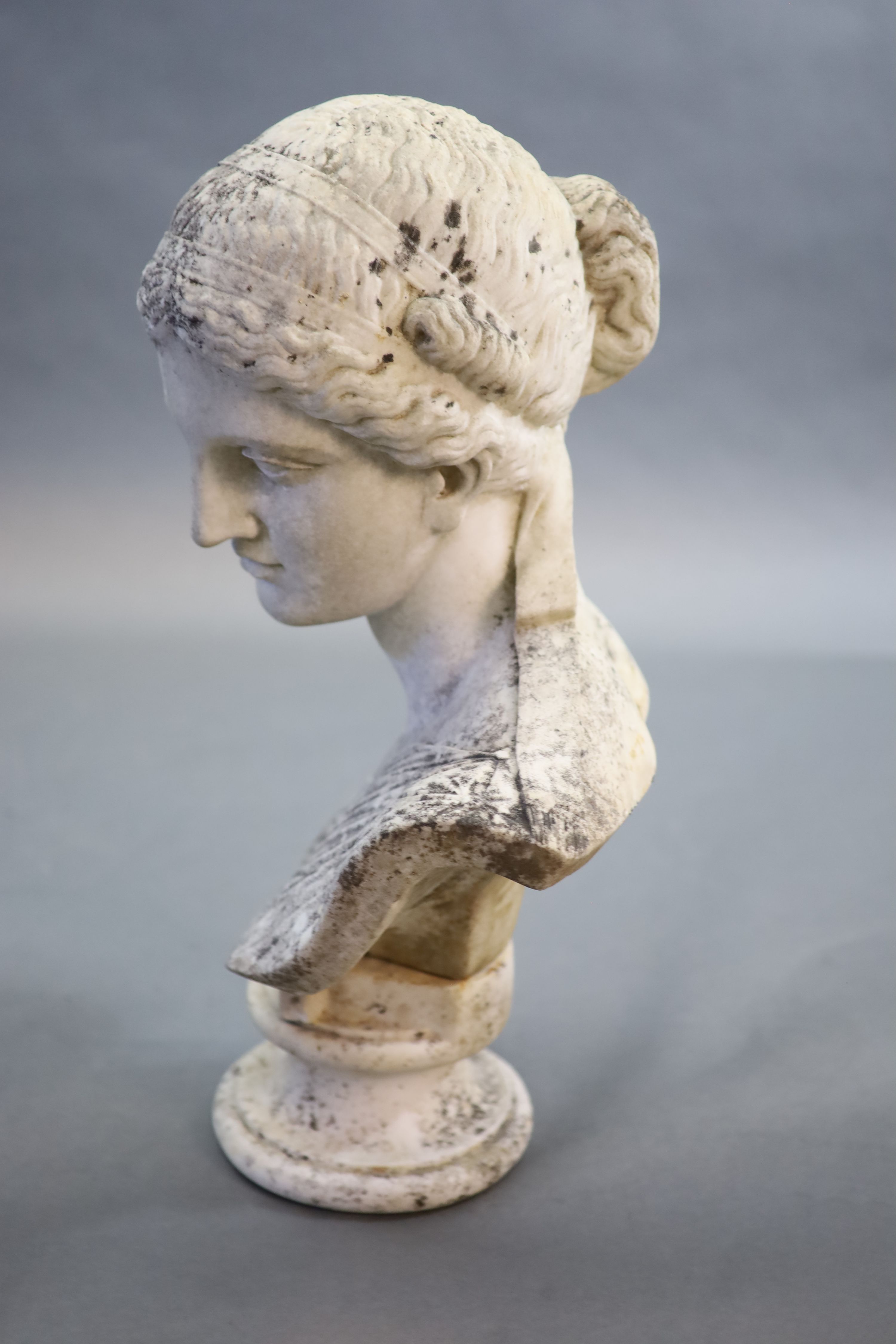 A large weathered white marble bust of a Grecian maiden, 19th centuryraised on an associated socle - Image 3 of 4