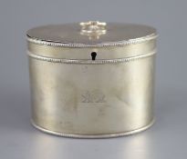A George III silver oval tea caddy by John Younge & Co,with engraved crest, ring handle and beaded