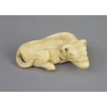 Manner of Tomotada (late 18th - early 19th century), a Japanese ivory netsuke of a recumbent ox,