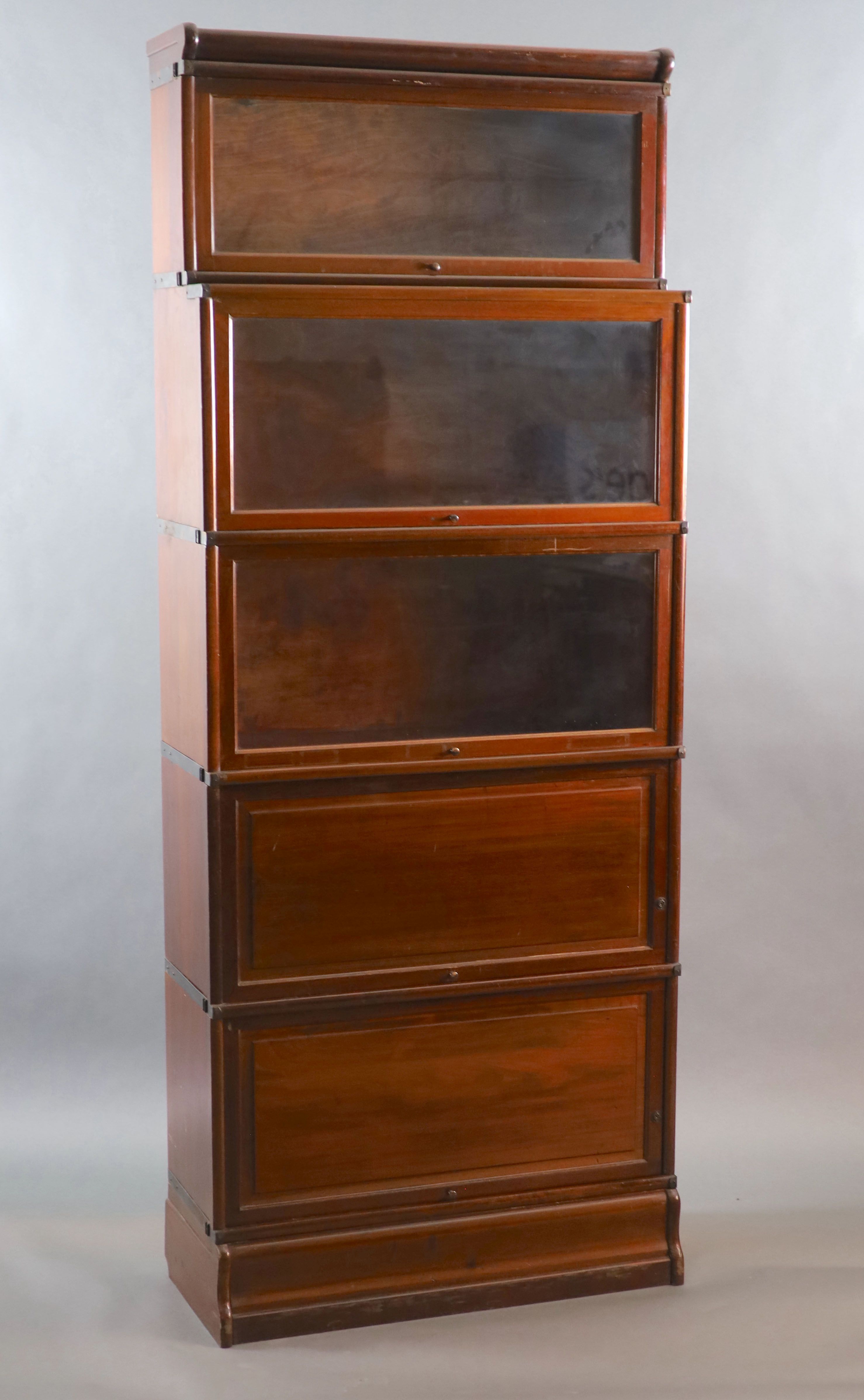 A Globe Wernicke mahogany sectional bookcase,with recessed glazed top tier over two glazed sections