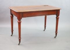 A Victorian mahogany writing table,with rounded rectangular top, once inset with a brass topped