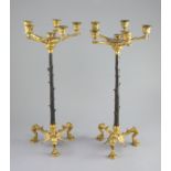 A pair of Barbedienne style five branch ormolu candelabra, 19th century,each raised on three puma