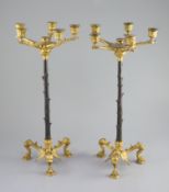 A pair of Barbedienne style five branch ormolu candelabra, 19th century,each raised on three puma