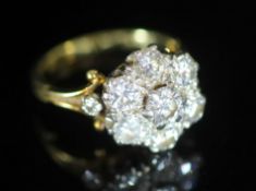 A mid 20th century gold and seven stone diamond cluster ring,with diamond set shoulders, total