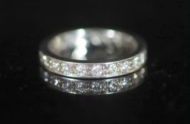 A mid to late 20th century platinum and diamond set full eternity ring,set with twenty one stones