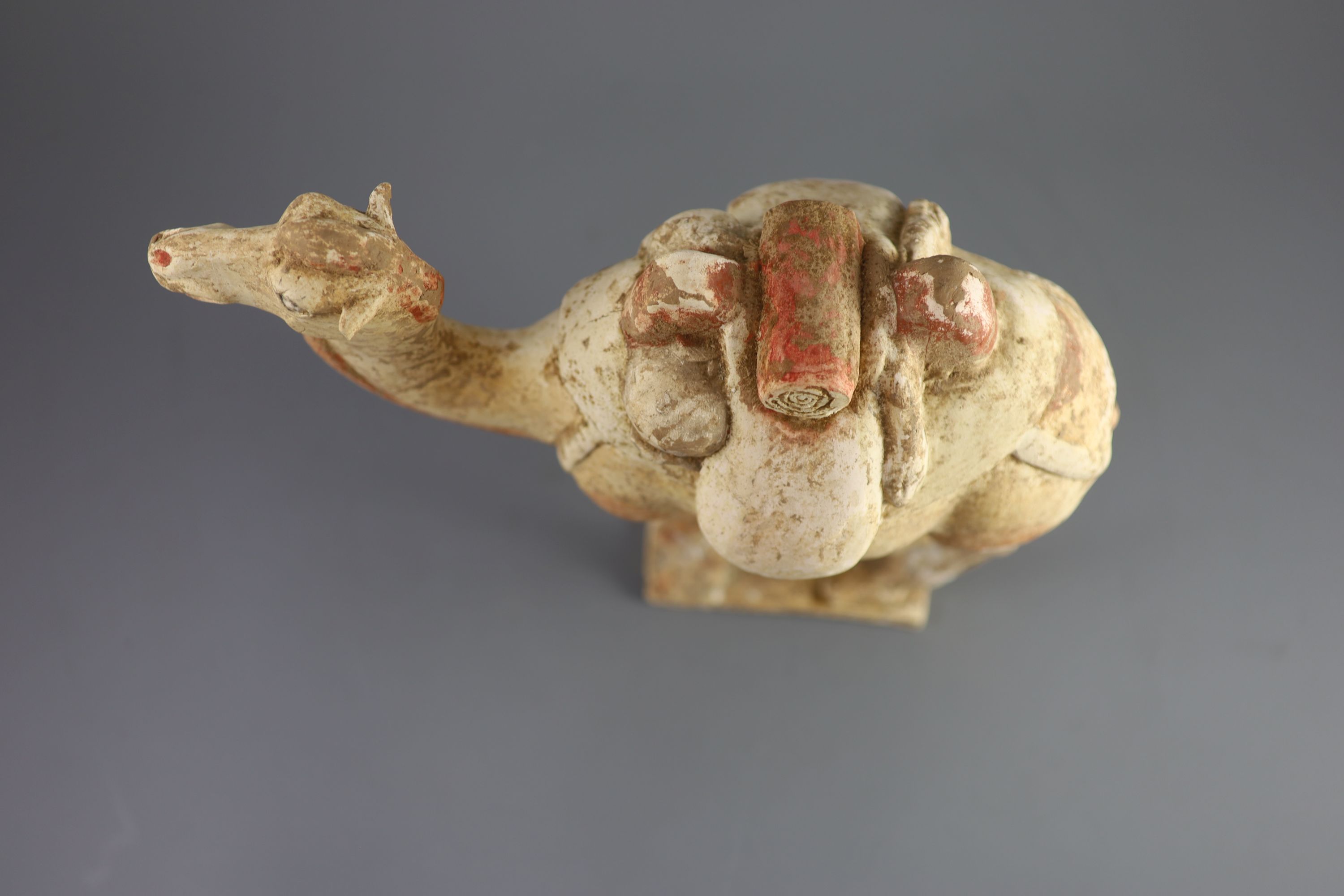 A Chinese pottery model of a Bactrian camel and a similar head of a man, Tang Dynasty,the buff - Image 3 of 5