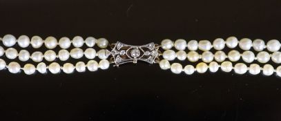 A three-row graduated pearl necklace with diamond-set openwork yellow metal clasp,44cm, gross