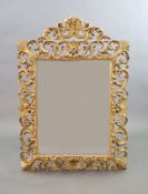 A late 19th century Florentine giltwood wall mirror,with foliate scroll frame and bevelled glass