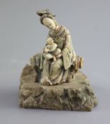 A Chinese soapstone group of Guanyin and child, probably Kangxi period,with remants of polychrome