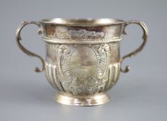A Queen Anne demi-spiral fluted silver porringer,with S-scroll handles, maker possibly John Rand,