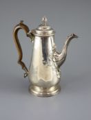 A George II silver coffee pot by Alexander Johnston,of tapering cylindrical form, with embossed