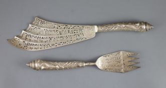 A cased ornate pair of Victorian silver fish servers, Aldwinckle & Slater,the blade and tines