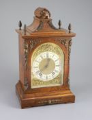 A late 19th century walnut cased bracket clock,with a silvered chapter ring with black Roman and