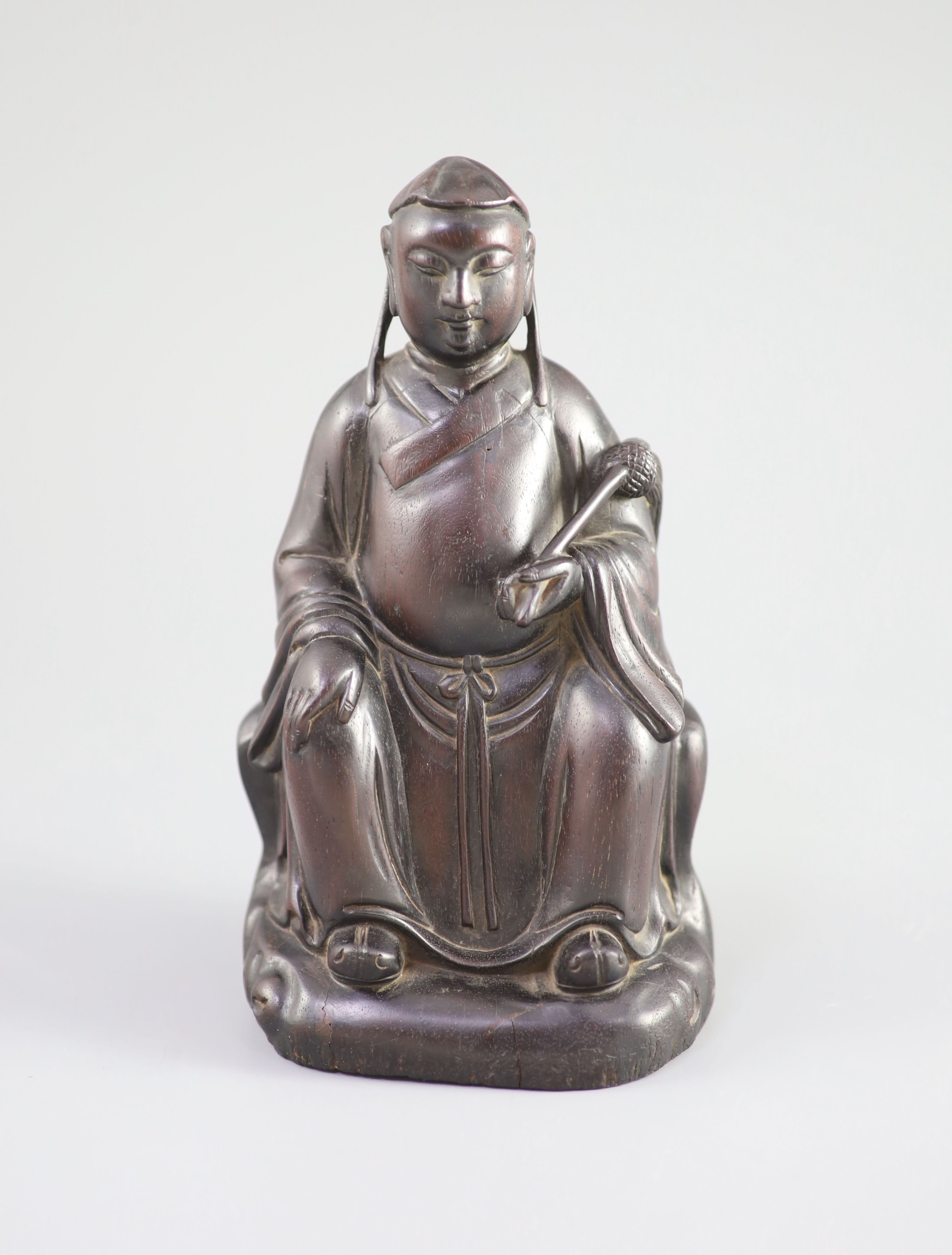 A Chinese Zitan seated figure of an official, 18th century,the figure holding a fly whisk in his