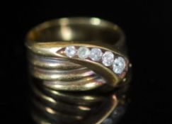 A George V 18ct gold and graduated five stone diamond set coiled serpent ring,size Q, gross weight