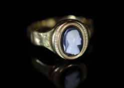 An early 19th century gold and cameo set poison ring,the hinged cover now revealing an eye