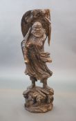 A large Chinese carved hardwood figure of a Luohan, 20th century,holding a Buddhist rosary, with