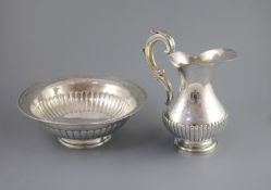 A mid 19th century Portuguese silver jug and bowl set,with engraved and demi fluted decoration,