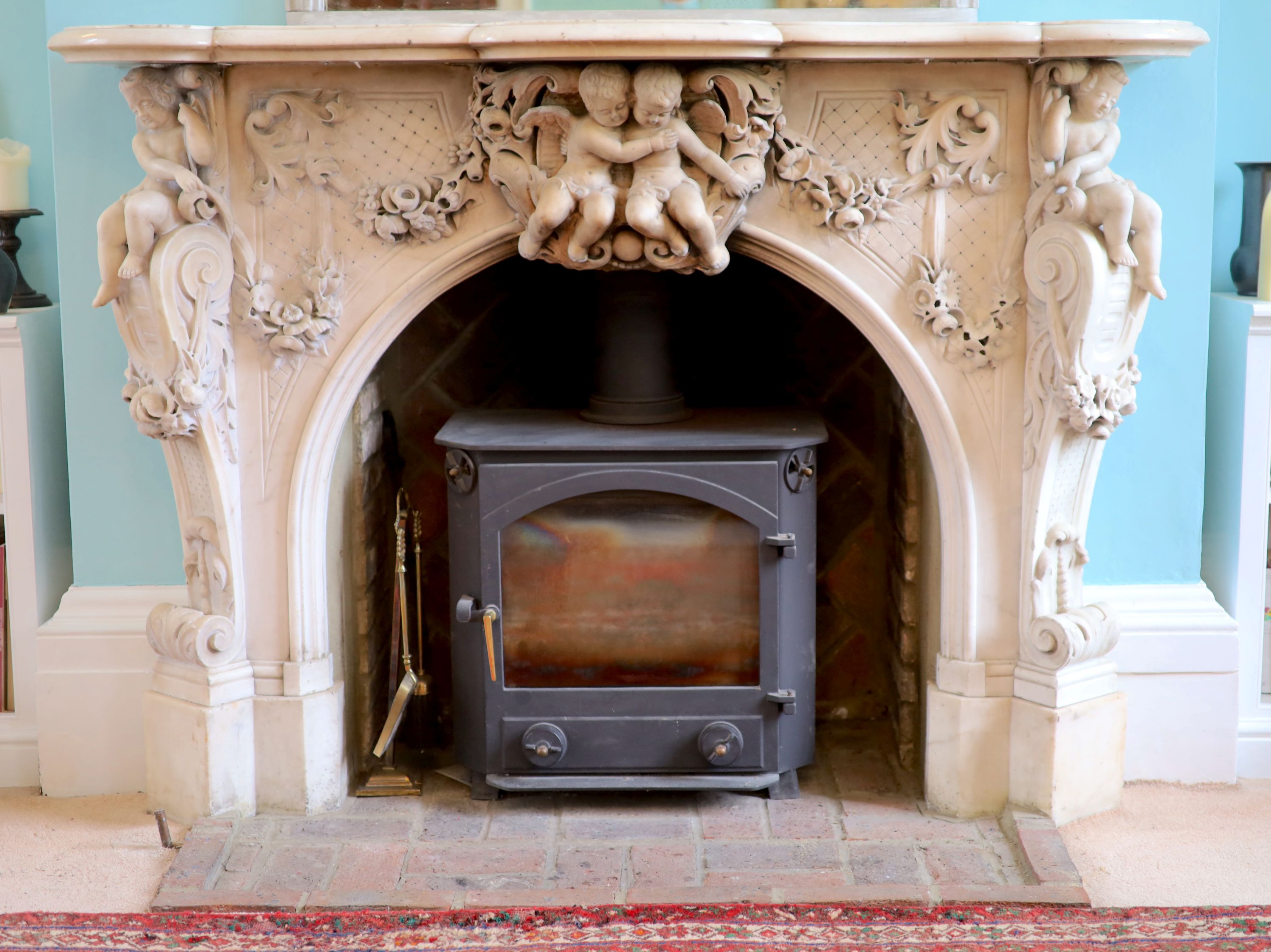 An important mid 19th century Italian white Carrara marble chimney piece,carved in the rococo
