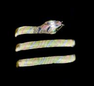 A mid to late 20th century three colour 18ct gold serpent bangle,with emerald set eyes, gross 32.2