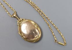 An Edwardian Art Nouveau 9ct gold oval locket, on a 9ct chain,locket overall 47mm, chain 41cm,