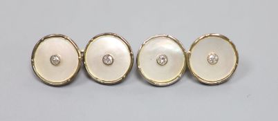 A pair of 18ct, mother of pearl and diamond set circular cufflinks,13mm, gross weight 5.8 grams.