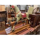 A 1920's F.H. Ayres painted wood rocking horse, on a trestle stand, fully restored in 2009 by