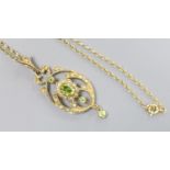 A modern 9ct gold, peridot and seed pearl set drop pendant, 47mm, on a 9ct chain, 46cm,gross 6.7