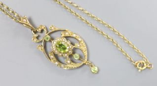A modern 9ct gold, peridot and seed pearl set drop pendant, 47mm, on a 9ct chain, 46cm,gross 6.7
