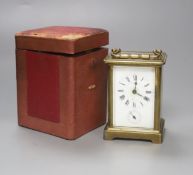 A French brass carriage alarm timepiece in leather case, 11cm high