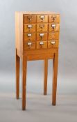 An early 20th century golden oak filing chest on stand, fitted twelve drawers, width 50cm depth