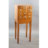 An early 20th century golden oak filing chest on stand, fitted twelve drawers, width 50cm depth