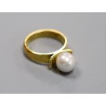 A modern 18ct and cultured pearl set dress ring, size M/N,gross 6.9 grams.