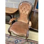 A Victorian walnut spoonback open armchair