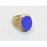 A modern 9ct gold and lapis lazuli set oval signet ring, with carved shoulders, size O,gross 6.9