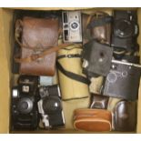 A quantity of cameras and lenses including Olympus