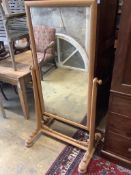 A large 19th century continental pale oak cheval mirror, with scrolling carved mounts, width 84cm,