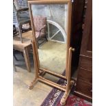 A large 19th century continental pale oak cheval mirror, with scrolling carved mounts, width 84cm,