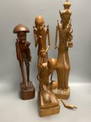 A group of three Balaris carved wood figures of mendicants and another similar figure, largest 52.