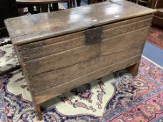 An early English oak six plank coffer, with shallow incised roundels and arched borders, 17th
