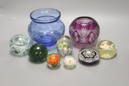 A group of coloured glassware including paperweights