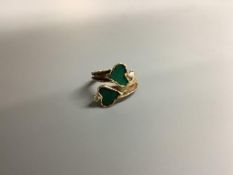 A modern yellow metal, two stone heart shaped malachite and two stone diamond set crossover ring,