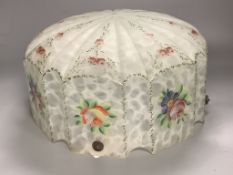 A large glass ceiling light with floral pattern