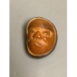 A Japanese carved nut mask netsuke