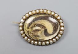 A Victorian yellow metal and split pearl set oval locket, with lock of plaited hair below a glazed