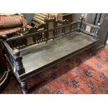 A Victorian Aesthetic period ebonised hall seat, the raised back with embossed glass inset panels,